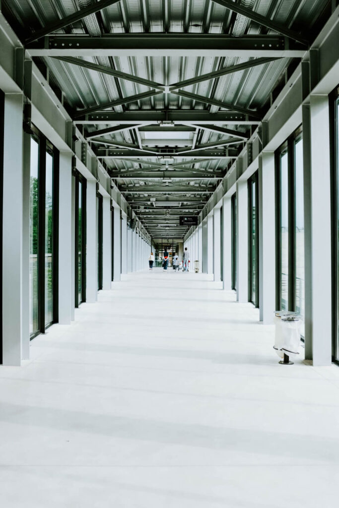 white hallway with glass doors and a metal ceiling